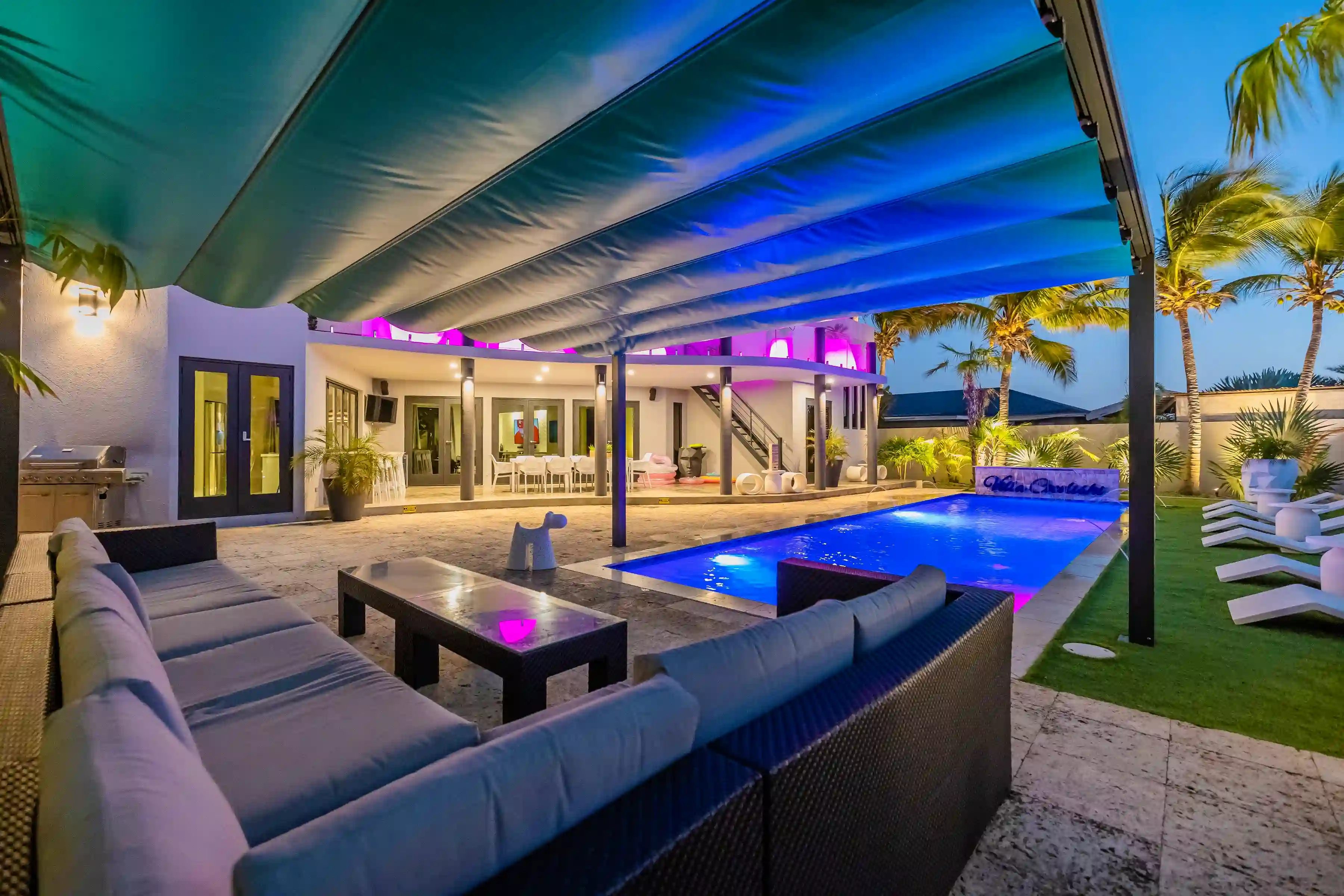 Evening relaxation station Recharge by our private pool, complete with comfortable lounge seating and stunning nighttime views