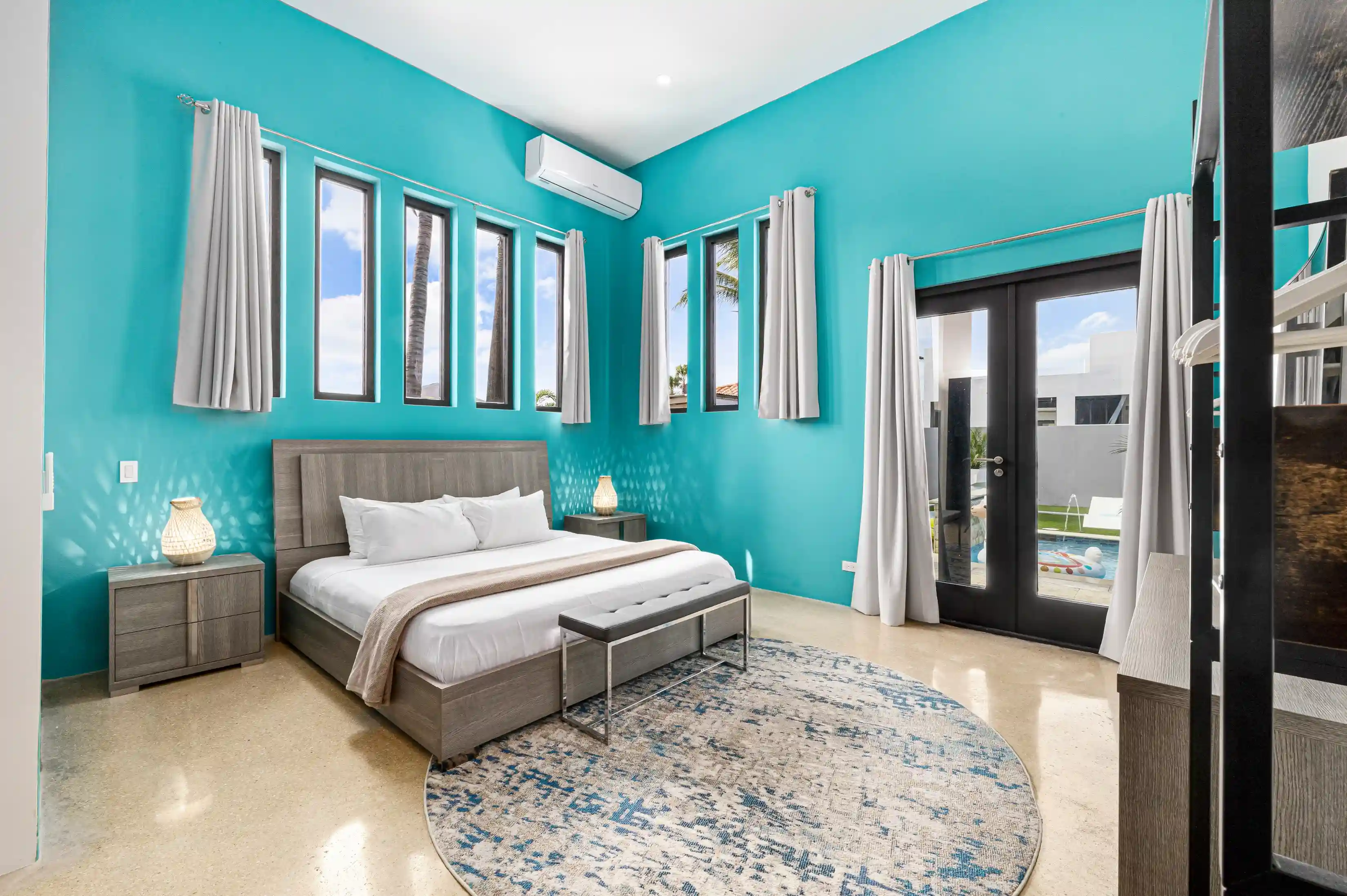 Ready to wind down in the large master bedroom, featuring a king sized bed and hotel quality linens. The master includes a personal air conditioner unit and easy access to the outdoors.